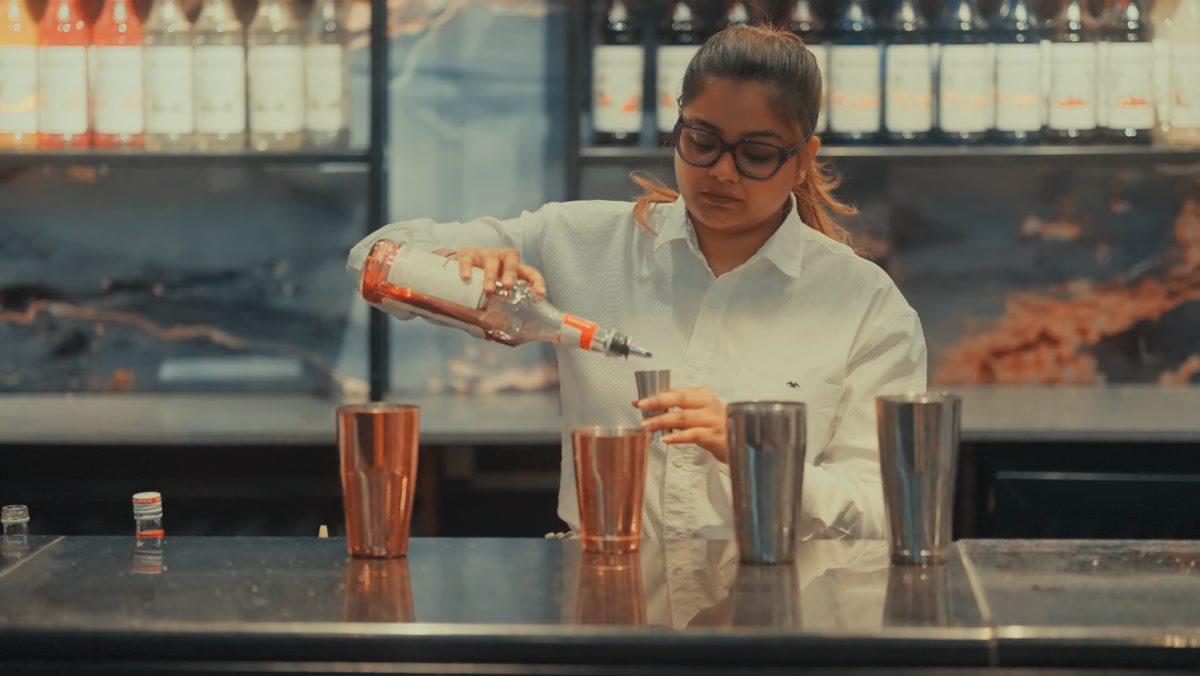 Bartender preparing a cocktail at The Bastian bar