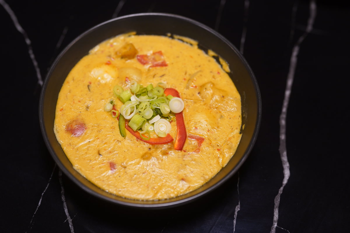 Yellow karahi curry with red peppers and spring onions