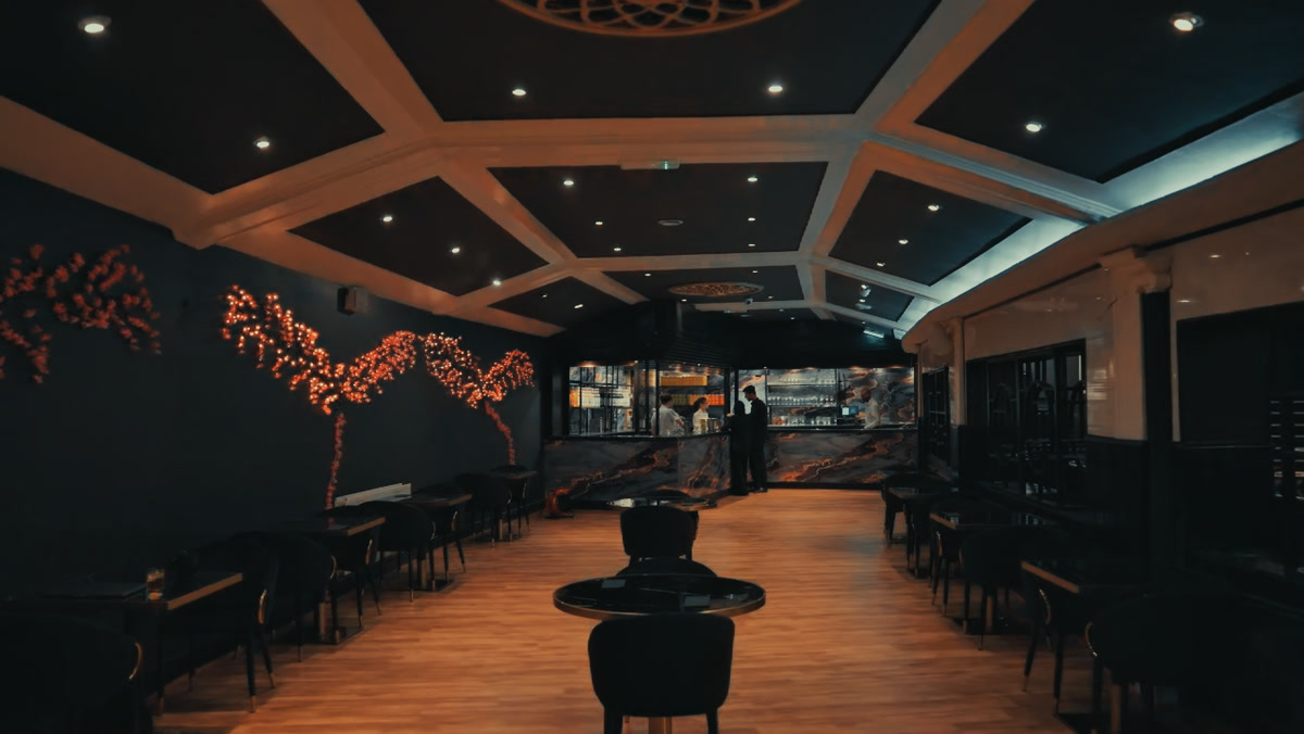 The Bastian dining hall with coffered ceiling and warm lighting